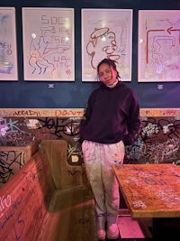 a woman standing in front of a table in a restaurant