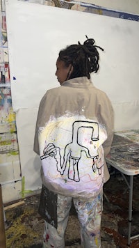 a woman wearing a jacket with a drawing on it