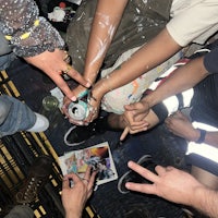 a group of people with paint on their hands