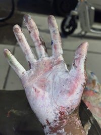 a person's hand with paint on it